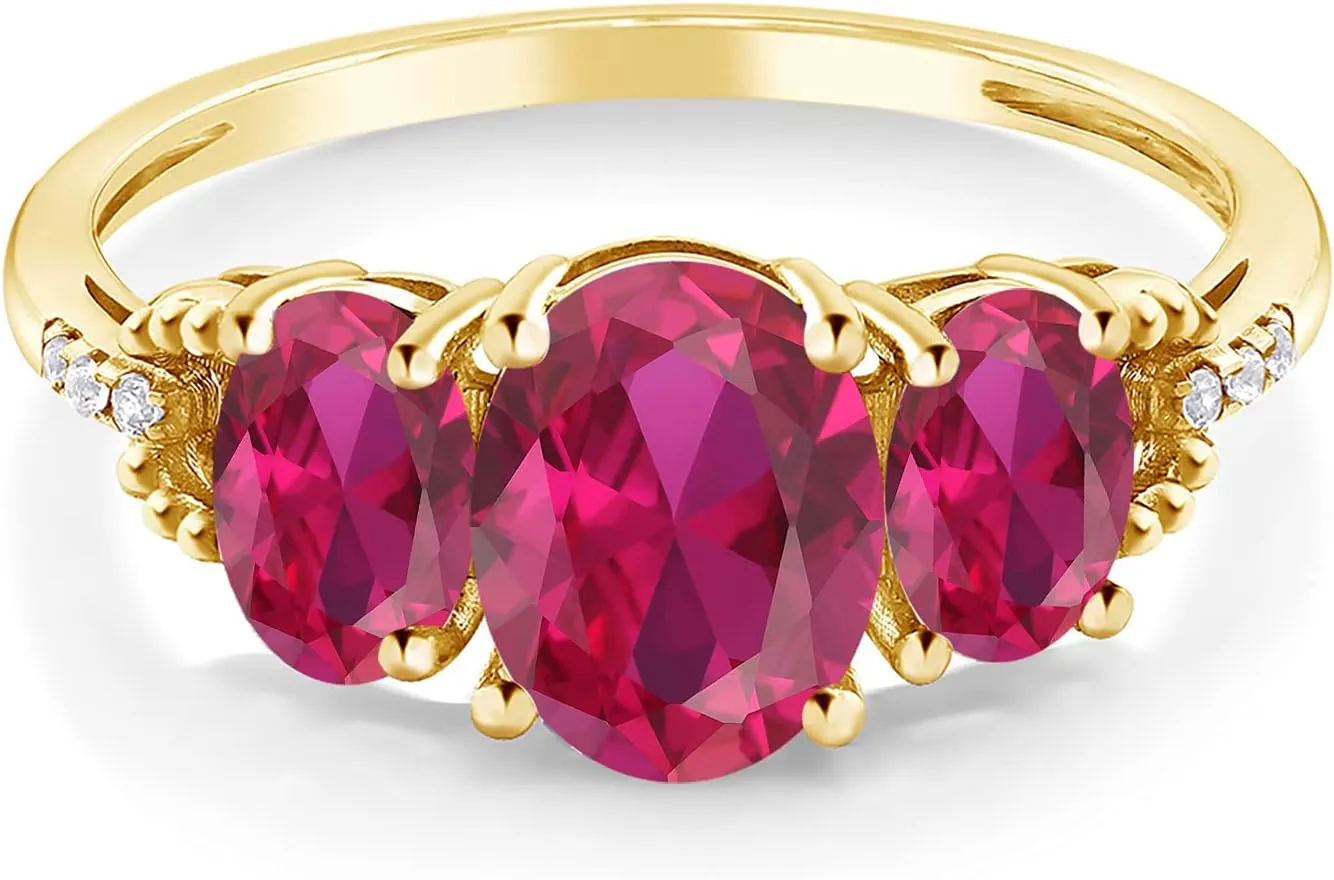 Gem Stone King 10K Yellow Gold Red Created Ruby and Diamond Accent 3 Stone Engagement Ring For Women | 2.54 Cttw | Oval 8X6MM and 6X44MM | Size 5-9.5